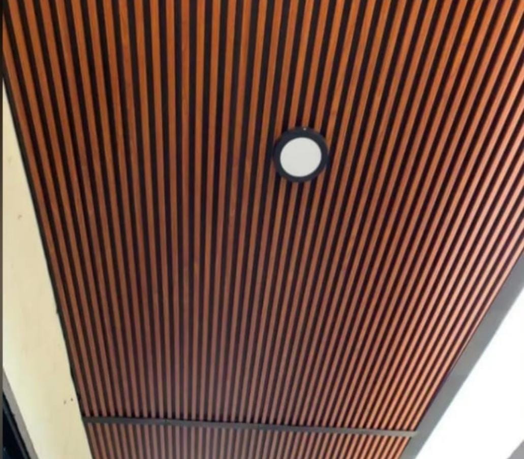 Custom patio cover with wood-look ceiling and integrated lighting